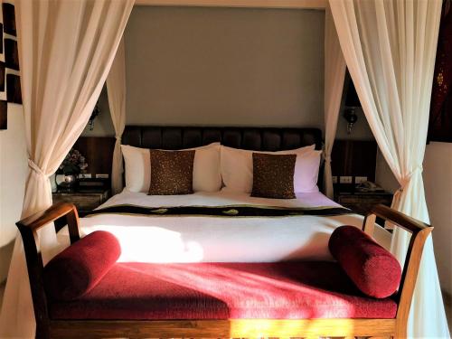 a bedroom with a large bed with a red blanket at A&L Inn 戀灣旅棧 in Nanwan