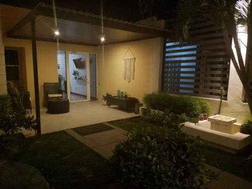 a house with a patio at night at Runway 108 in Managua