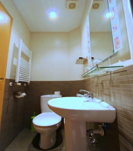 a bathroom with a white sink and a toilet at Hostal Regio in Madrid