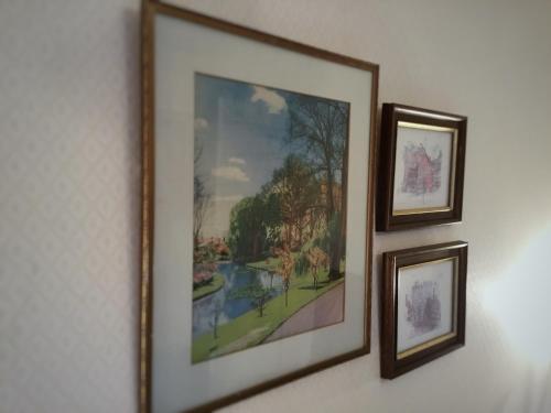 two framed pictures of a painting on a wall at Royal Mail Hotel in Lumsden