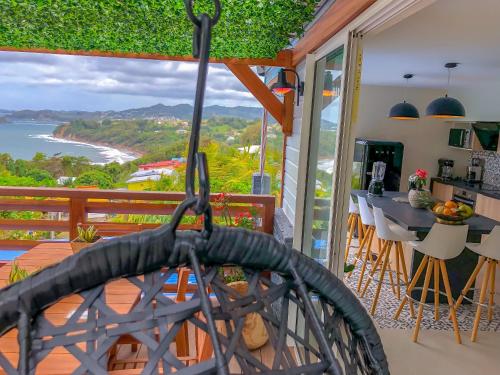 a view of the ocean from the balcony of a house at Résidence Nakiya in Sainte-Marie