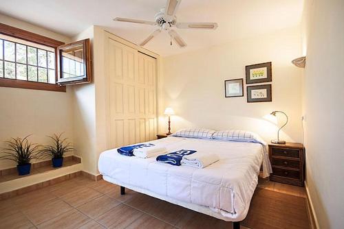a bedroom with a bed and a ceiling fan at Sol in Jávea