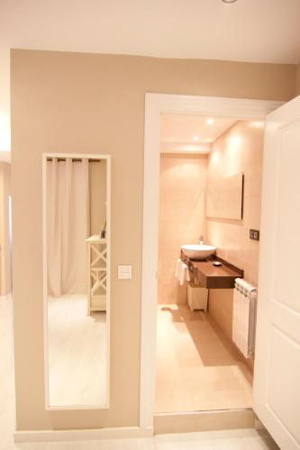 a bathroom with a sink and a mirror at Apartamentos Las Vegas in Ribadesella