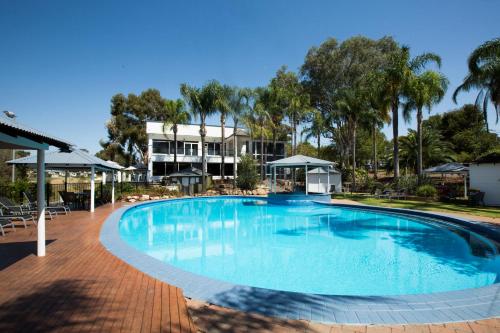 a large swimming pool in front of a resort at Lake Hume Resort in Lake Hume