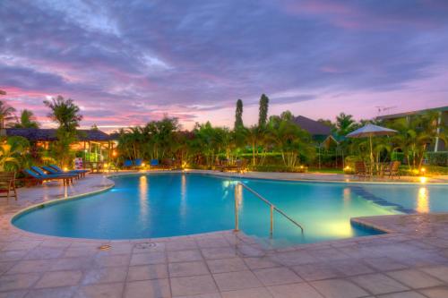 a large swimming pool at a resort at dusk at Tanoa Waterfront Hotel in Lautoka