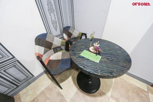 a table with a chair and a table with at Sky Motel in Wonju