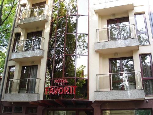 a building with a sign on the side of it at Favorit Hotel in Sofia