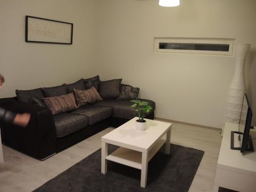 a living room with a couch and a table at Pearl in Raahe