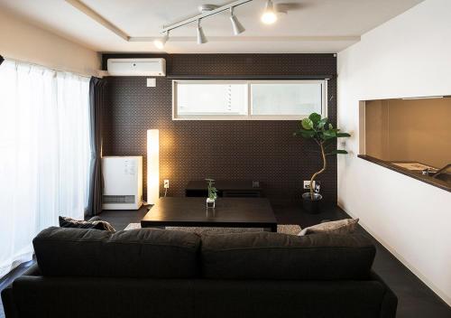 a living room with a couch and a table at PINN-N4E2Ⅰ in Sapporo