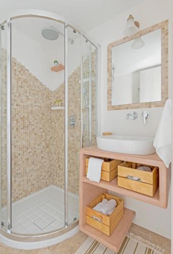 a bathroom with a shower and a sink at Parathinalos Beach House in Livadi Astypalaias