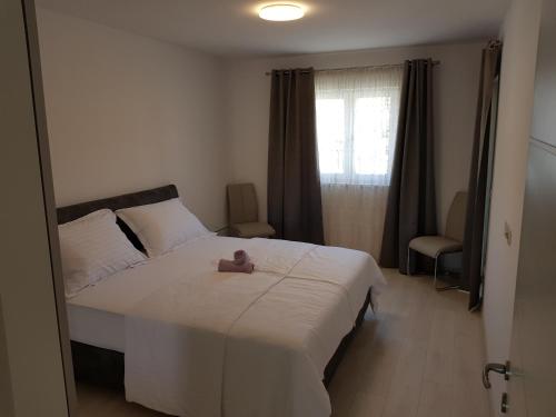 Postel nebo postele na pokoji v ubytování Apartmani MARELLA