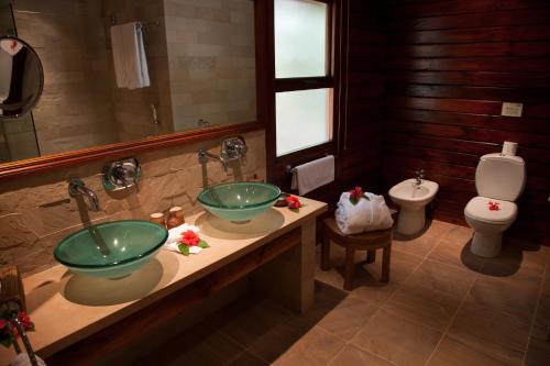 a bathroom with two sinks and a toilet at Cerf Island Resort in Cerf Island