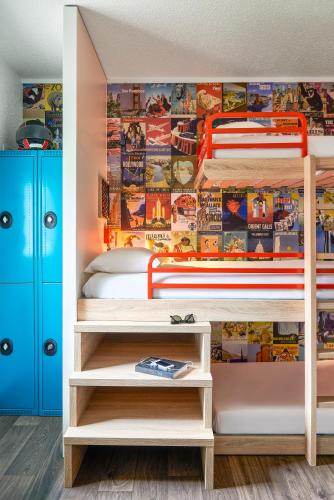 a bedroom with a bunk bed with a superhero mural at hotelF1 Toulouse Aéroport in Blagnac
