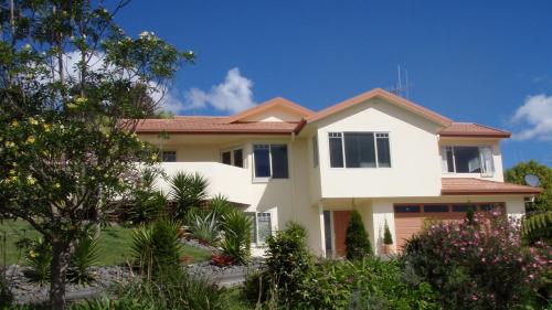 a white house with a red roof at Seascape Villa B&B in Tauranga