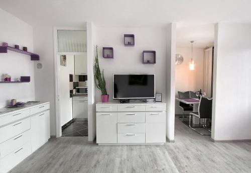 a white kitchen with a tv and a desk at Studio Blue Ivy in Plitvička Jezera