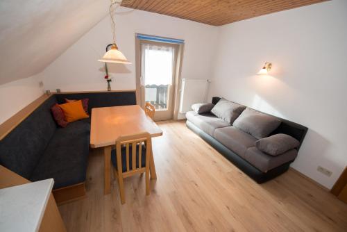 a living room with a couch and a table at Haus Binder in Weissensee