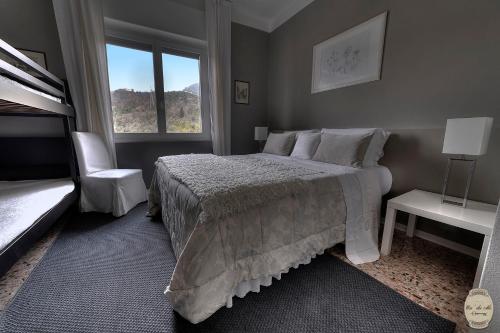 a bedroom with a bed and a chair and a window at Ca' Du Ale in Sestri Levante