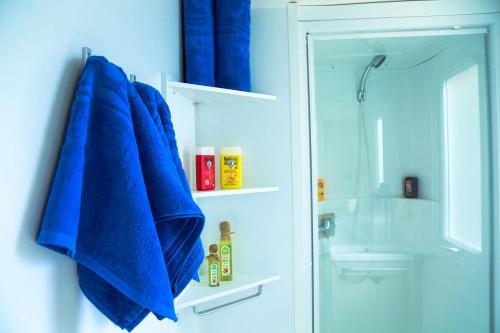 a blue towel hanging on a wall in a bathroom at LOCA BEACH in Taghazout