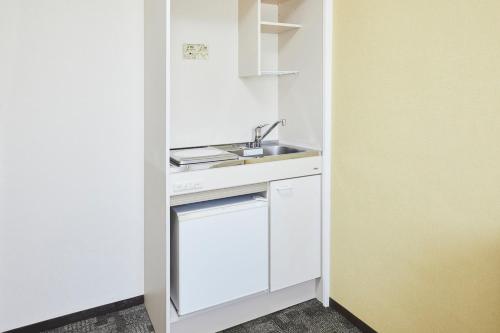 a small kitchen with a sink and a dishwasher at FLEXSTAY INN Higashi Jujo in Tokyo