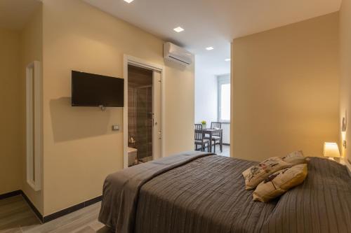 a bedroom with a bed and a flat screen tv at Le stanze di Carla! Con cucina e bagno privato in Florence