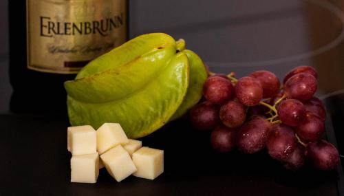a bunch of grapes and cheese and a bottle of wine at Ferienhaus Butterfly in Garmisch-Partenkirchen