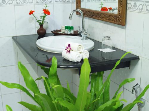 a bathroom with a sink and a mirror at Soma Palmshore in Kovalam