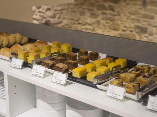 a display case filled with different types of pastries at Carris Casa de la Troya in Santiago de Compostela