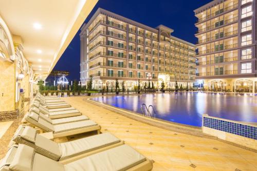 a hotel with a pool in front of a building at LK Celestite in Pattaya South