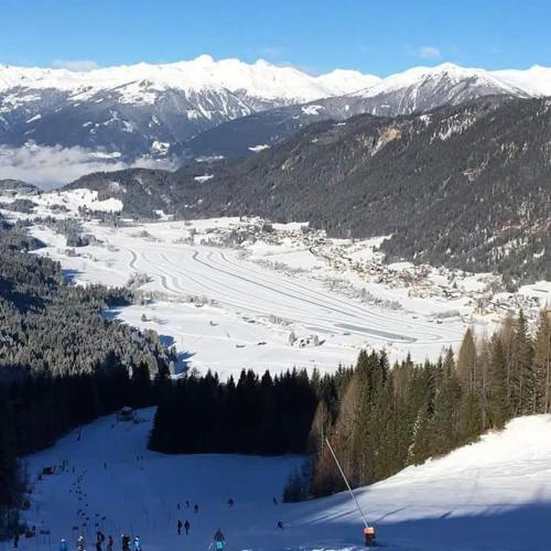 a group of people skiing down a snow covered mountain at Haus Binder in Weissensee