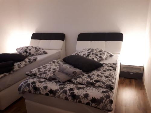 two beds with pillows on them in a room at Bitscher str.70 in Zweibrücken