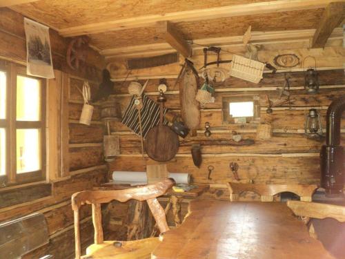 a wooden room with a wooden table in a cabin at Etno kuce Miljevic in Šipovo