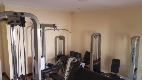 a gym with several mirrors in a room at Esperanca Guesthouse in Windhoek