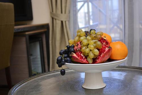 a bowl of fruit sitting on top of a table at Hotel Classic in Tbilisi City