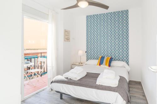 A bed or beds in a room at Berlanga, apartamento en el centro