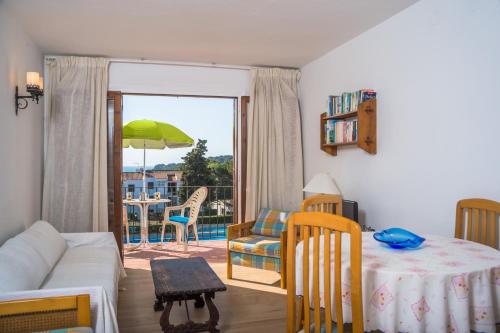 a living room with a couch and a table and a patio at M-1 CALELLA DE PALAFRUGELL 4 PAX in Calella de Palafrugell