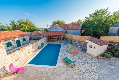 an image of a swimming pool in the backyard of a house at Villa Petrovi Dvori ZadarVillas in Benkovac