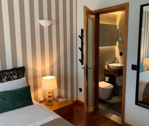 a bedroom with a bed and a bathroom with a sink at Near the Airport in Moreira