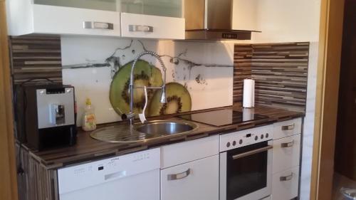 a kitchen with a sink and a counter top at Fewo-Seither in Rudersdorf