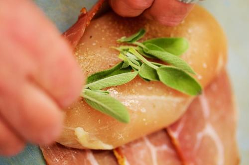a person holding a piece of food with leaves on it at Hotel Reussischer Hof in Schmölln