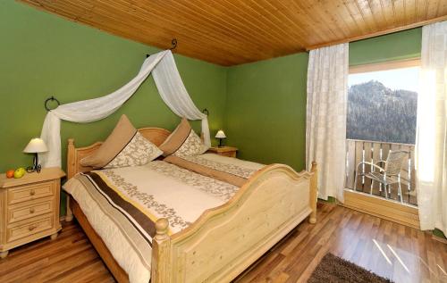 a bedroom with a bed with a canopy at Montara Suites Bodenmais I aktivCARD Bayerischer Wald inklusive in Bodenmais