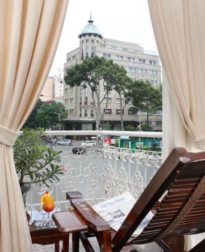 a view of a city street from a balcony at Hotel Continental Saigon in Ho Chi Minh City