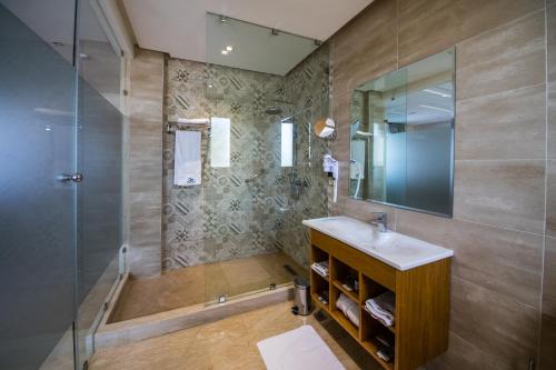a bathroom with a sink and a shower at Rim Aquatique Hôtel & Nature in Fès