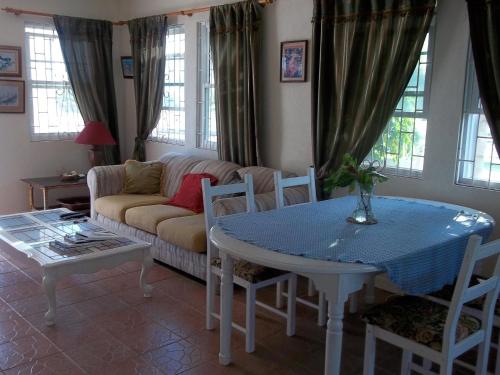 a living room with a table and a couch at Ocean Ridge at Long Beach in Christ Church