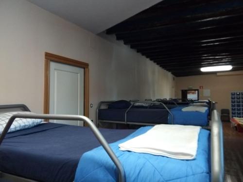 a room with three beds in a room at ALBERGUE CASA BAZTAN in Uterga