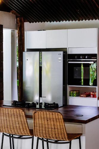 a kitchen with a wooden table and two chairs at La Cabane in Jimbaran