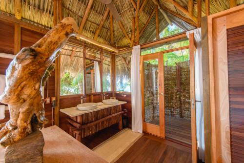a room with a bathroom with a shower and a sink at Calala Island in Set Net