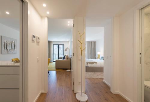 een witte kamer met een slaapkamer en een bed bij LovelyStay - Downtown Balcony Apartment with Free Parking in Porto