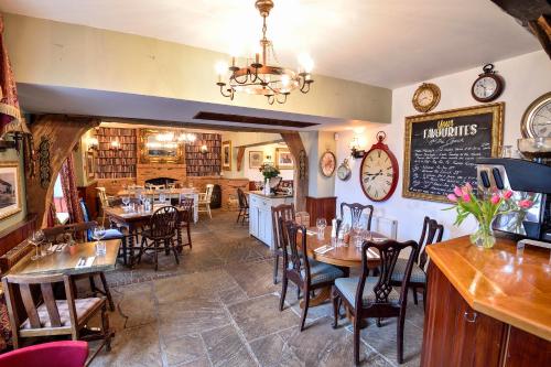a dining room with tables and chairs in a restaurant at The Coach and Horses in Worthing