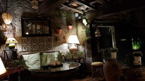 a room with a table and a lamp and plants at Mar Del Sueve in Colunga
