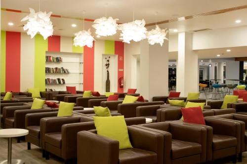 a waiting room with brown chairs and colorful pillows at Luna Miramar Club in Albufeira